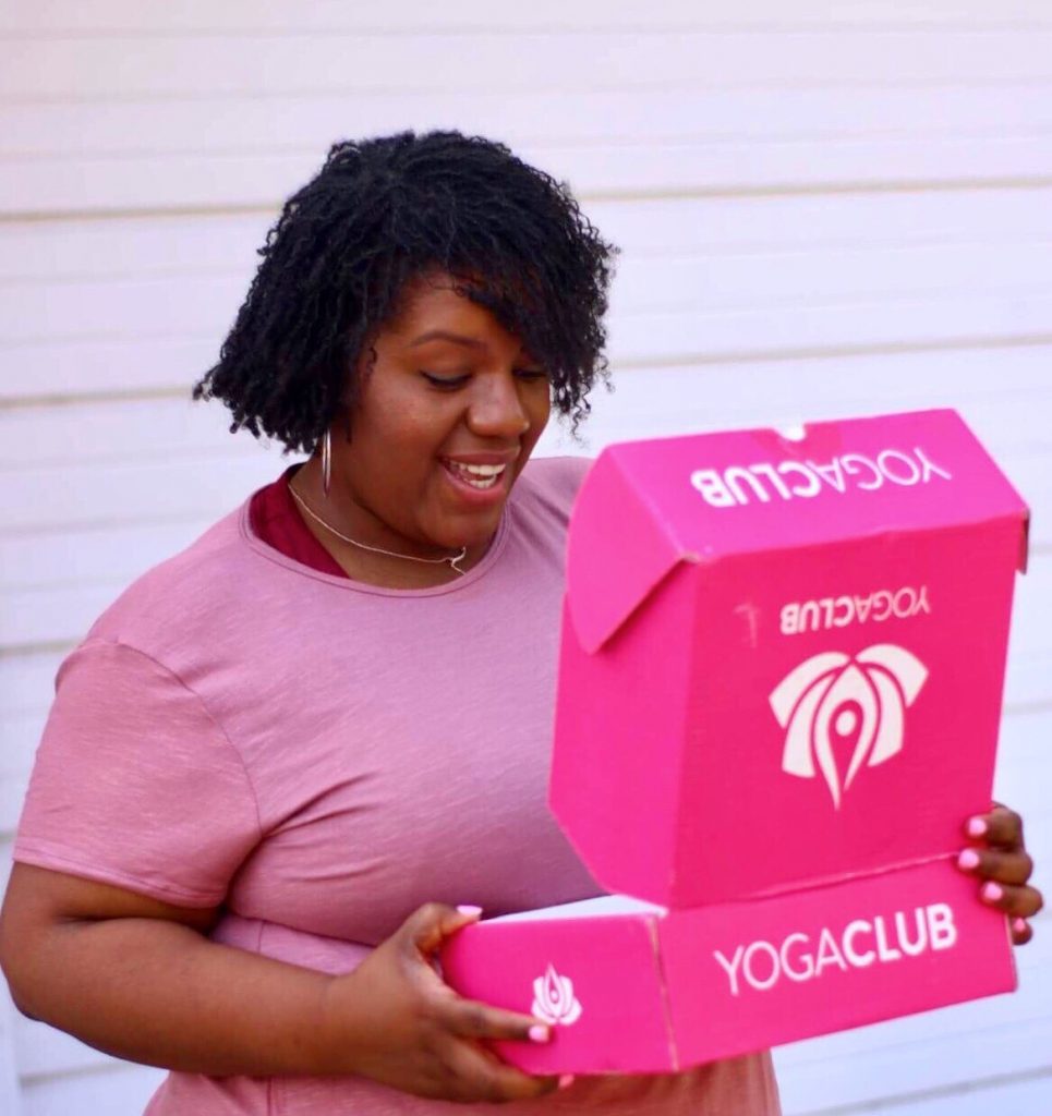 plus size woman looking at a yoga clubbox